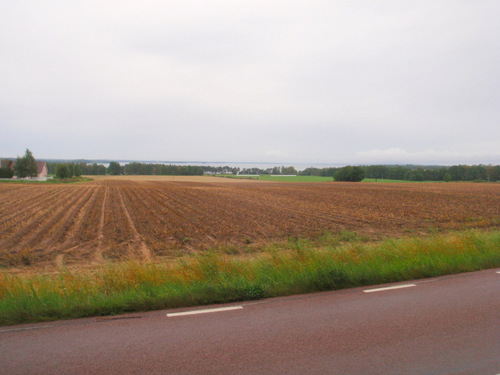 Flat field with Lake Vättern on the horizon.